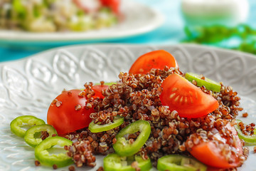 Salad with quinoa and vegetables on plate, closeup