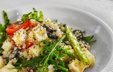 Salad with quinoa and vegetables on plate, closeup