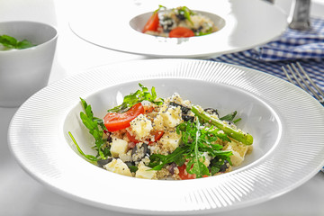 Plate with quinoa salad on table, closeup