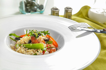 Plate with quinoa salad on table, closeup
