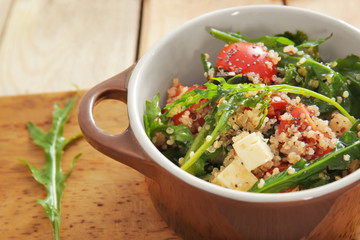 Salad with quinoa and vegetables in casserole on table