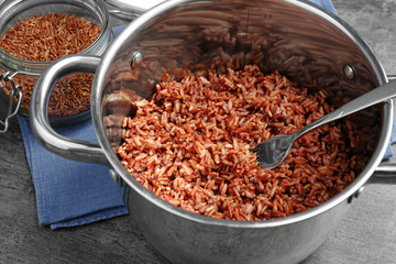 Cooked rice in saucepan on table