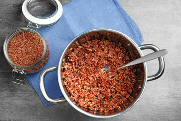Cooked rice in saucepan on table