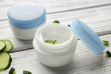 Jar with cucumber cream on table