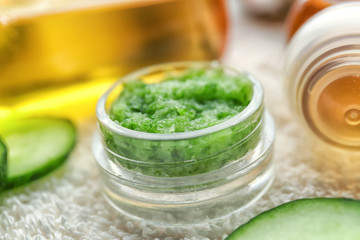 Jar with cucumber mask on table