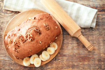 Tasty banana nut bread on wooden board