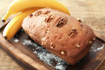 Tasty banana nut bread on wooden board