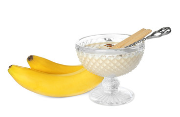 Dessert bowl with tasty banana smoothie on white background