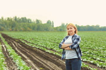 Naklejka na ściany i meble Female farmer standing in field
