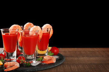 Composition with shrimps and tomato sauce in glasses on table