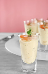 Glass of white sauce with shrimp on table, closeup