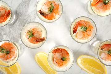 Glasses of white sauce and shrimps on table, closeup