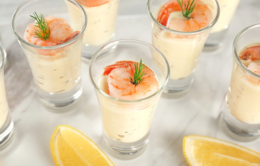 Glasses of white sauce and shrimps on table, closeup