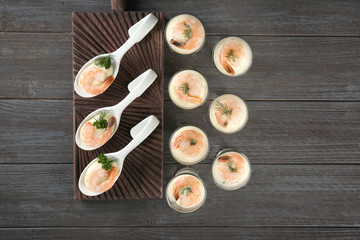Composition with tasty shrimps and white sauce on table