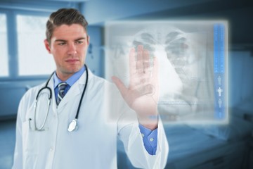 Composite image of male doctor touching an digital screen 3d