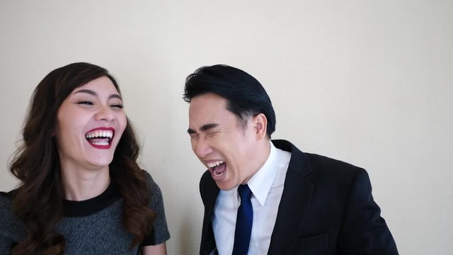 Business man and woman laughing.
