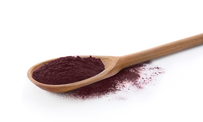 Wooden spoon and acai powder on white background