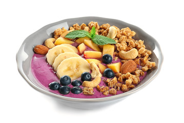 Healthy breakfast with delicious acai smoothie on plate, isolated on white