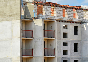 Close up photo of unfinished building. Construction site. Contemporary urban landscape.  Developing of modern civil engineering. Construction industry