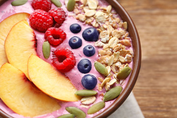 Healthy breakfast with delicious acai smoothie in bowl, close up
