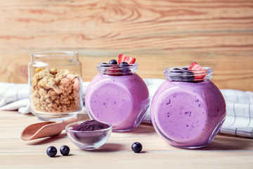 Delicious acai smoothie in jars on table