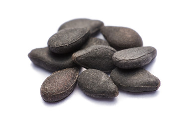 Fototapeta na wymiar Close up pile of black sesame seeds isolated on white background