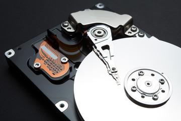 System for recording and reading information. The components of the hard drive on a black background.