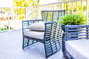 Chairs and green plant in new house closeup with decorations on balcony in staging model home or apartment