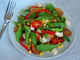 Fitness salad with corn. Arugula corn pepper cheese. Top view.