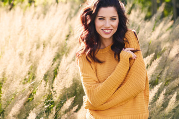 portrait of a beautiful woman in an autumn yellow sweater.