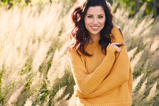 Portrait Of A Beautiful Woman In An Autumn Yellow Sweater.