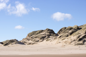 Fototapeta na wymiar Grassy Sand Dunes at Newburgh Beach in front of Blue Sky