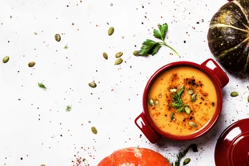 Foto auf Acrylglas Fertige gerichte Spicy pumpkin soup in a serving pan, top view