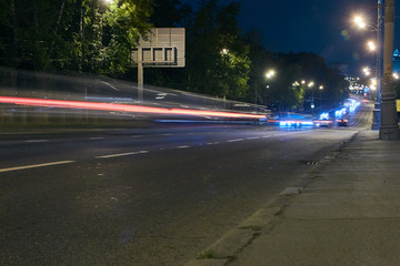 Automobile traffic on a city street at night