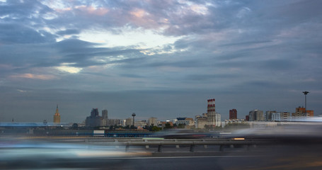 Fototapeta na wymiar Automobile traffic on a city street at sunset