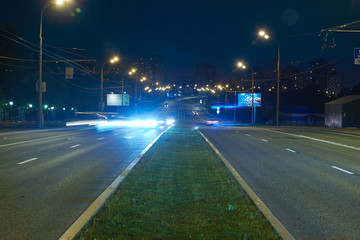 Automobile traffic on a city street at night