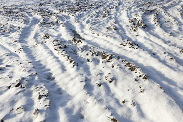 Fototapeta na wymiar Snow drifts on the ground