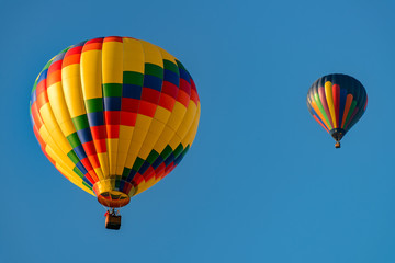 Colorful hot air balloons against blue sky