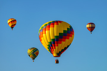 Colorful hot air balloons against blue sky