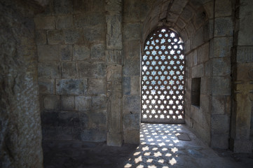 Some rays of sunshine pass through a door inside the Qutub Minar complex in New Delhi in India.