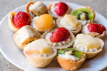 Mini Tarts, Tartolet or Tartlets with cream and fresh fruits