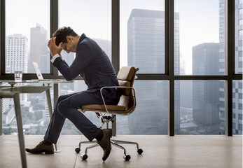 Stressed young businessman overworking