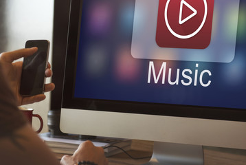 A guy listening to music on his computer