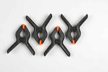 four black pegs on a white background