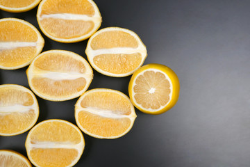 cut in half lemons on a dark background