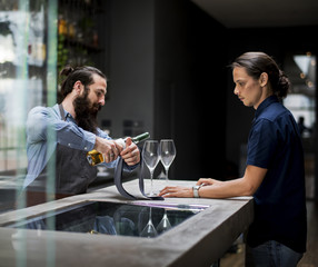 Bartender pouring a wine to the glass