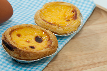 egg tarts on wooden plate
