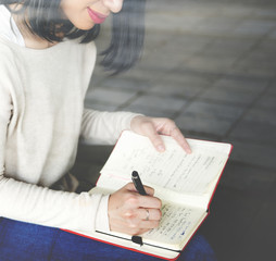Asian woman writing notes