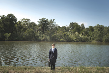 Fototapeta premium Businessman lost in nature