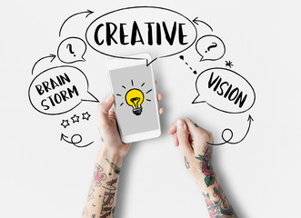 Tattooed woman holding a phone with a light bulb on it